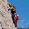 woman climbing on sheer rockface